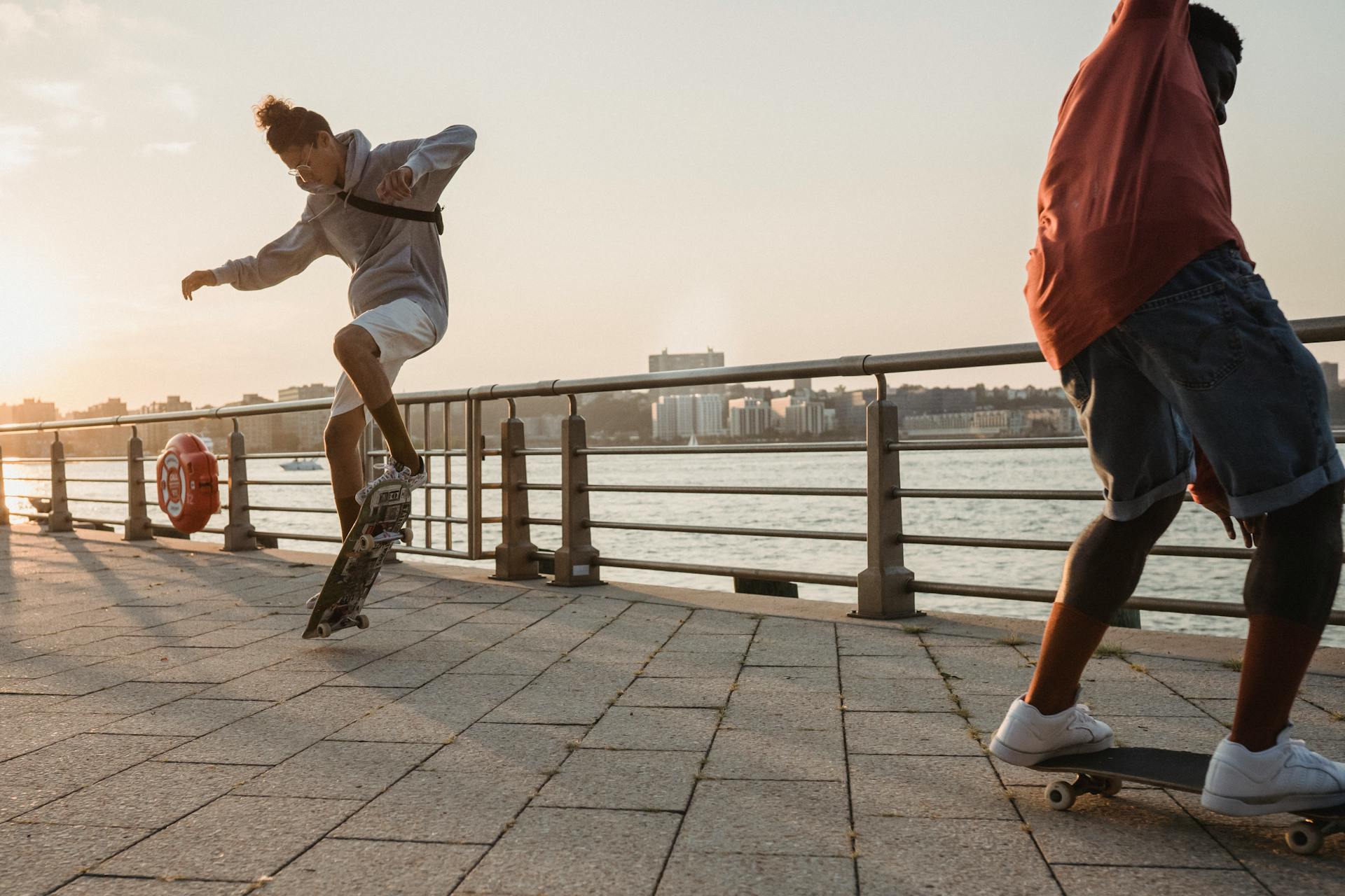 Two skateboarders at sunset — Photo by Budgeron Bach · Pexels 5159228